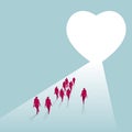 A group of businessmen walk towards a heart shaped symbol.